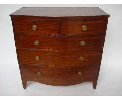 A 19th Century mahogany bowfront chest of drawers, with two short and three long graduated cockbeaded drawers, with later bra