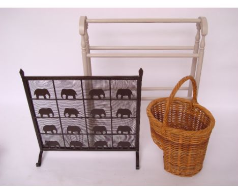 A grey painted towel rail, a black painted metal fire screen with elephant design and a wicker stair basket (3). 