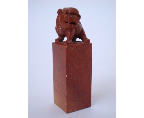 A Chinese red soapstone seal, carved with dog of Fo finial. 