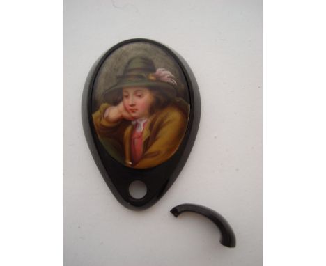 A Victorian Whitby Jet pear shape pendant, inset with an oval porcelain plaque painted in enamel colours with a Tyrolean boy,