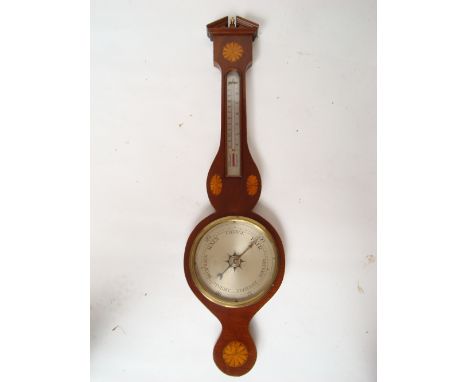 An Edwardian Regency style mahogany wheel barometer, inlaid with fan patterae and with barbers pole stringing, surmounted by 