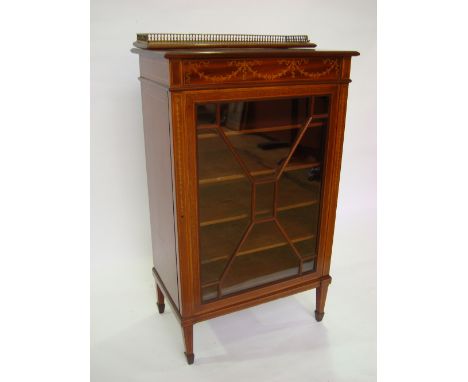 A late Victorian mahogany sheet music cabinet, the satinwood crossbanded top above a frieze inlaid with marquetry ribbon tied