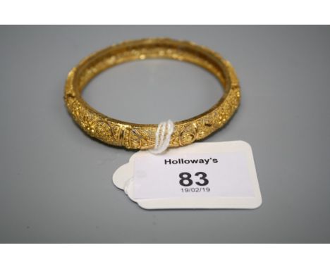A ornate pierced and engraved bangle, of concave form, marked '22'
