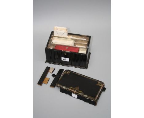 A Victorian papier maché tea caddy, later converted for stationery, containing several dozen largely Edwardian visiting cards