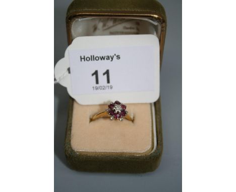 A ruby and diamond double row cluster ring, claw mounted to a plain shank