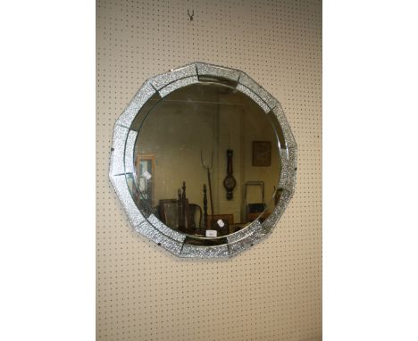 A 1930's Art Deco wall mirror with central circular plate and twelve peripheral clear/ frosted plates, 70cm diameter