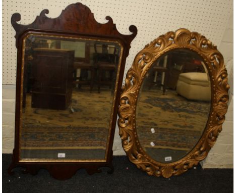 An Edwardian mahogany fret framed wall mirror with gilded slip and bevelled plate, together with a carved giltwood mirror wit