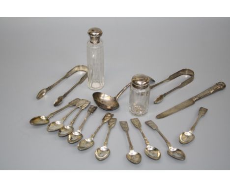 A silver sauce ladle, two pairs of silver sugar nips, ten bright cut decorated silver teaspoons, two dressing table bottles w