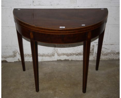 A George III mahogany card table, the crossbanded 'D' shape foldover top on boxwood fan inlaid square tapering legs with doub