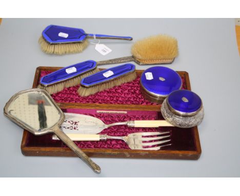 Two silver mounted and blue enamel decorative dressing table boxes, a confirming five piece mirror and brush suite, and a cas