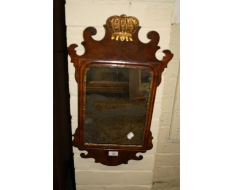 A George II mahogany fret framed wall mirror, of small proportions, with gilded coronet surmount and slip enclosing a rectang