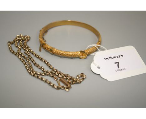 A late Victorian 9ct gold bangle, with chipped decoration and buckle motif, together with a 9ct gold open link chain