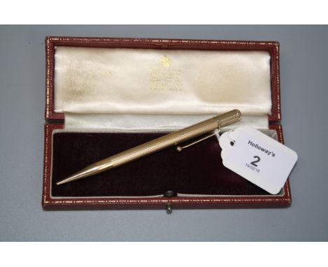 A 9ct gold propelling pencil with engine turned barrel, 12cm, 22gm