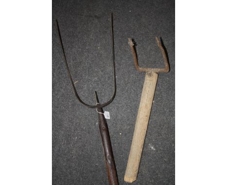 A 19th century pitch fork with elm handle and hand tiller of similar period