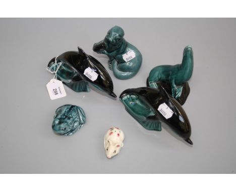 Two Poole pottery dolphins, a sealion, otter and frog, each green glazed together with a cream glazed mouse