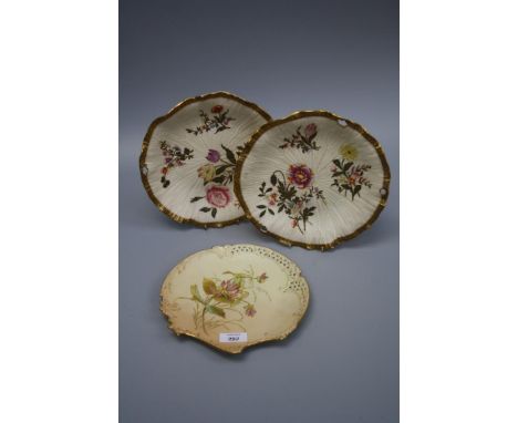A near pair of Royal Worcester blush pierced plates decorated with spring and summer flowers together with a fan shaped plate
