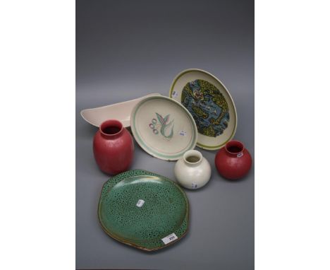 A small collection of Poole pottery including a speckled green glazed dish, a boat form dish, three vases and two other plate