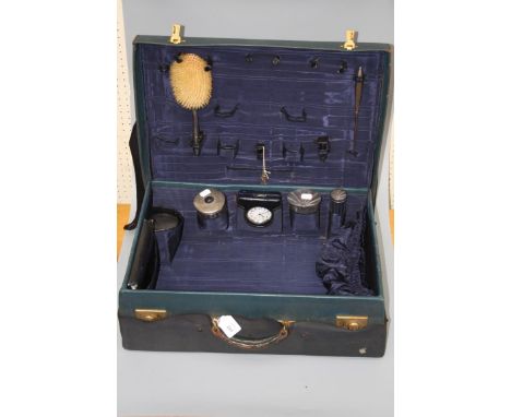 A cased travelling toilet set, in blue leather carrying case, partially fitted with four various engine turned  toilet jars, 