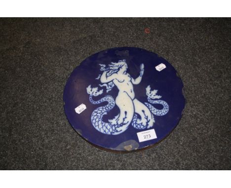 A large Mintons tile of disc form, decorated with a twin tailed mermaid holding a toilet mirror, 28.5cm diameter, impressed m