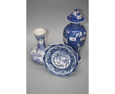 A Chinese tall lidded jar decorated with prunus on a blue scale ground, 39cm, a squat onion form vase and a blue and white pl