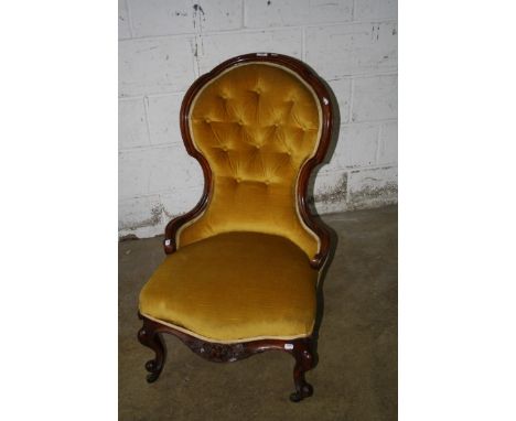 A Victorian walnut framed lady's spoon back salon chair, with mustard button upholstery, on cabriole forelegs, knuckle feet a