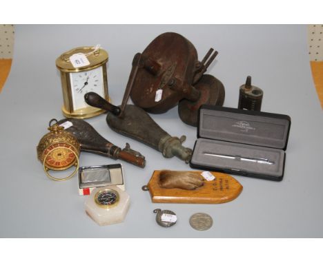 Two 19th century leather shot flasks, a brass flask, a mounted otter paw with Army and Navy plaque, a Carborundum grinding wh