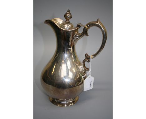 E.M. a silver hot water jug, of baluster form with bud finial and scrolled handle, Edinburgh 1867, 26.5cm