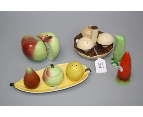 A Carltonware three piece cruet fashioned as fungi, an apple form salt and pepper, a three piece fruit cruet on a banana stan