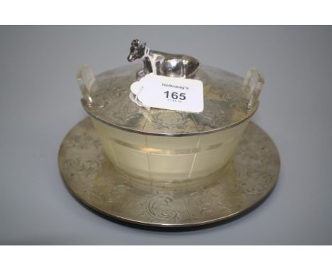 G.R., E.B., a frosted and clear cut glass butter dish, the florally engraved panel cover with recumbent cow finial, on a conf