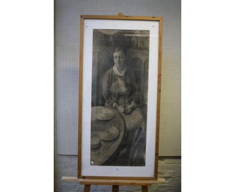 Jane Bond (b.1939), full length portrait of a lady seated beside an oval table, charcoal, 119 x 47cm, signed to stretcher ver