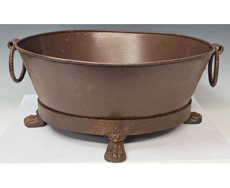 An oval metal iron ring handled oval bath tub planter, lion paw feet, 57.5cm wide over handles, 24cm high 