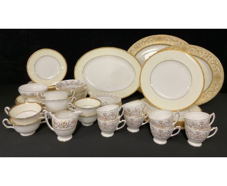 A Wedgwood dinner service for six, cream border, gold rim, comprising dinner plates, dessert plates, side plates, tea plates,