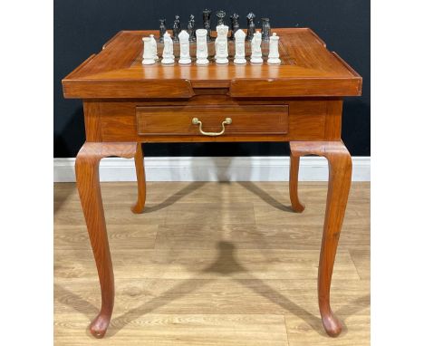 A contemporary games table, removable square top inlaid for chess, the verso with baize, enclosing a surface for backgammon, 