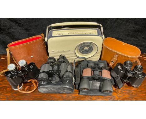 Four cased sets of binoculars; a vintage Bush transistor radio 