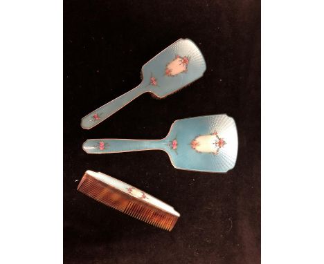 An Enamelled silver dressing table set, comprises hand mirror, handled brush and comb, engine turned and enamelled in bright 