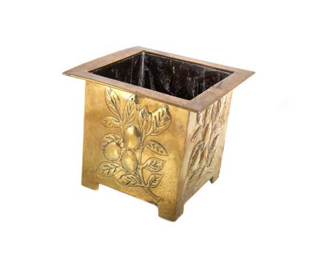 ARTS & CRAFTS BRASS PLANTER CIRCA 1900-20 of square section, the sides embossed and engraved with fruiting foliage, on bracke