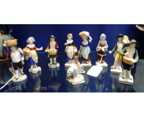 A SMALL COLLECTION OF CERAMIC FIGURES CARRYING BASKETS, some with apples