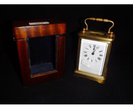 A BRASS CASED CARRIAGE CLOCK  in later travelling case