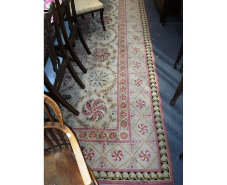 A LARGE FRENCH AUBUSSON TYPE CARPET with a central neo-classical oval within foliate  paterae 142" x 182" (approx) 