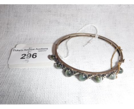 AN EDWARDIAN CATS-EYE CRYSOBEL AND SEED PEARL BANGLE