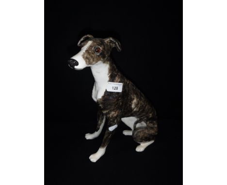 A WINSTANLEY CERAMIC MODEL OF A SEATED GREYHOUND