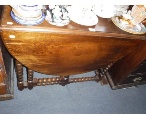 AN OAK GATELEG TABLE on bobbin turned supports 36" wide