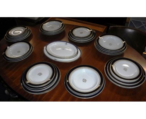 A QUANTITY OF ROYAL WORCESTER DINNER WARE, decorated with gilt within a Royal blue border and three Minton serving dishes wit