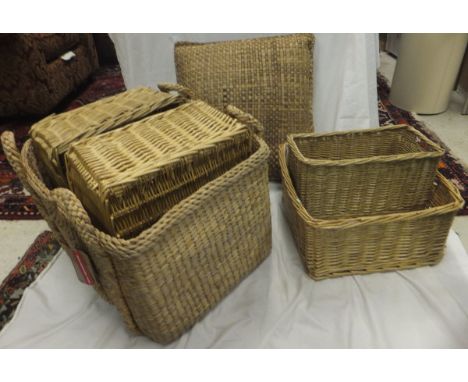 A large collection of wicker and woven baskets to include laundry baskets, etc, together with a woven rush cushion