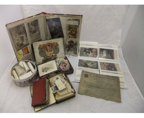 Two albums of various World War I period and later postcards, together with assorted cigarette cards, a "1950 The Internation