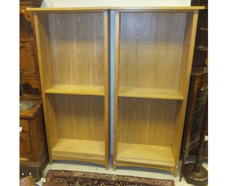 A pair of modern light oak adjustable bookcases
