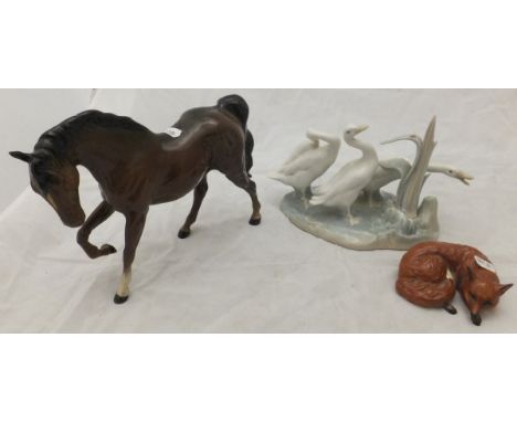 A Royal Doulton figure of a horse, a Beswick figure of a fox, a Lladro figure group of three ducks, together with a large box