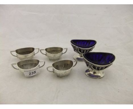 A pair of Edwardian pierced oval salts raised on reeded oval bases (by Haseler Bros., London 1905), and a set of four Victori