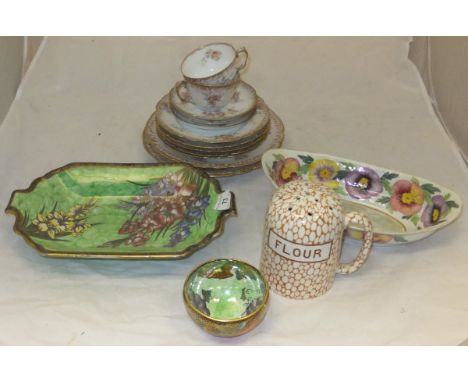 An early Maling bowl on three small feet with orange ground decorated with grapes on vine to outer and green ground with grap