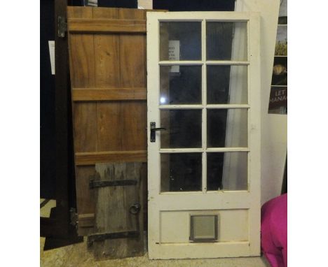 Seven various hardwood and other doors, wall shelf, two small iron bound cabinet doors, and two wrought iron racks CONDITION 